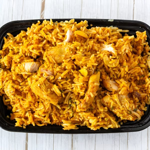 Chicken Biryani from India House, a flavorful Indian rice dish with chicken pieces and cashews.